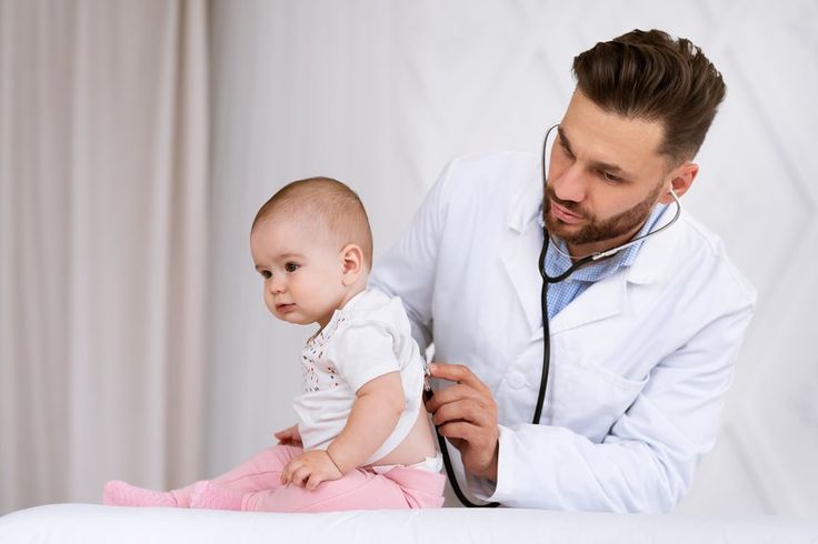 Doctor listening to a small child’s chest with a stethoscope
