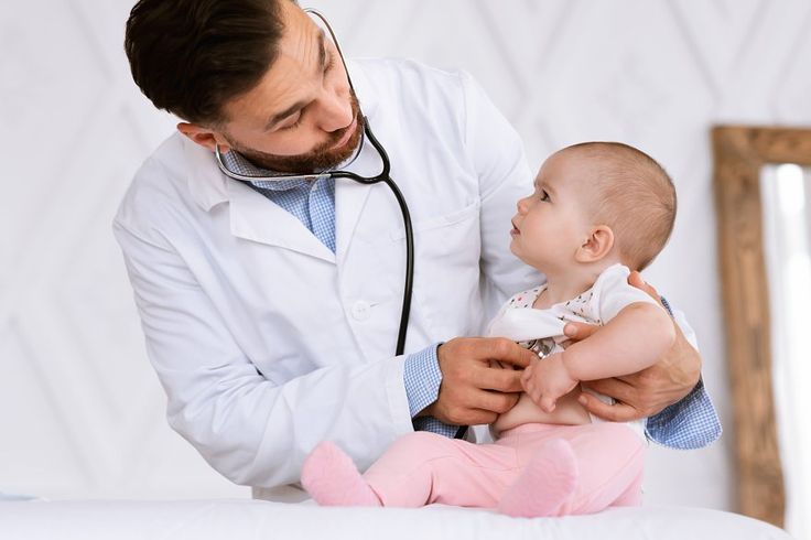 Doctor examining a small child during a routine check-up